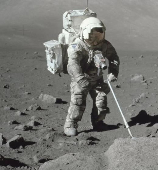 Colour photograph of Jack Schmitt with his spacesuit covered in moondust.